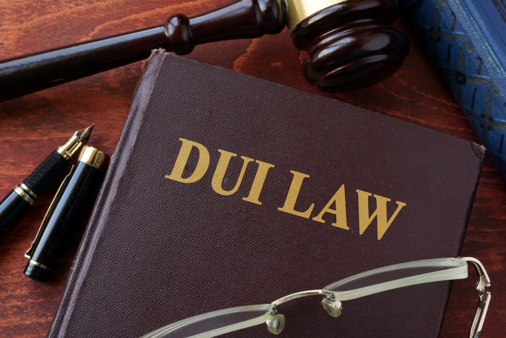 DUI Lawyer guide with law book, gavel, eyeglasses, and pens. DUI Lawyer legal guide featuring a DUI law book, judge’s gavel, eyeglasses, and pens, highlighting expert legal defense and guidance for anyone facing a drunk driving charge.