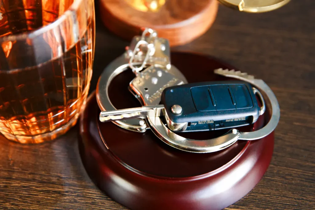 DUI Lawyer representing drivers facing drunk driving charges with car keys and handcuffs. DUI lawyer is helping drivers facing drunk driving charges, with car keys, handcuffs, and alcohol highlighting the importance of legal representation after a DUI arrest.