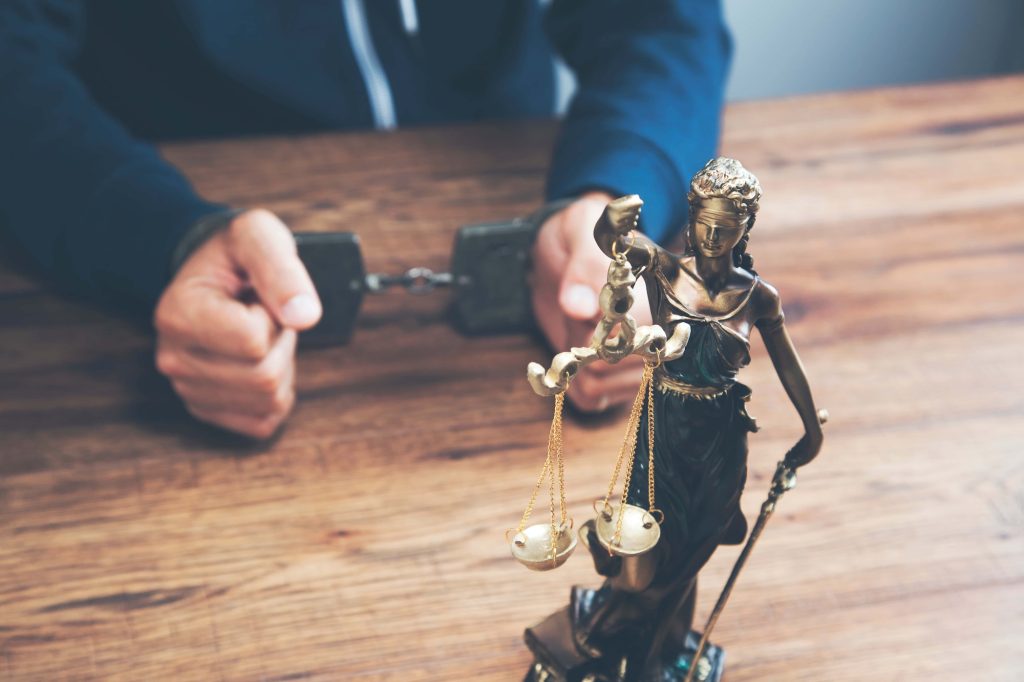 Domestic Assault Charges and Legal Justice Domestic assault legal concept with handcuffs and Lady Justice, symbolizing criminal charges, legal consequences, and defendants’ rights.